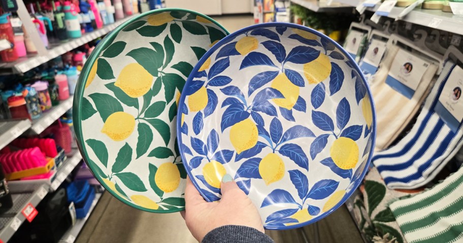hand holding up green and blue lemon print dinner bowls