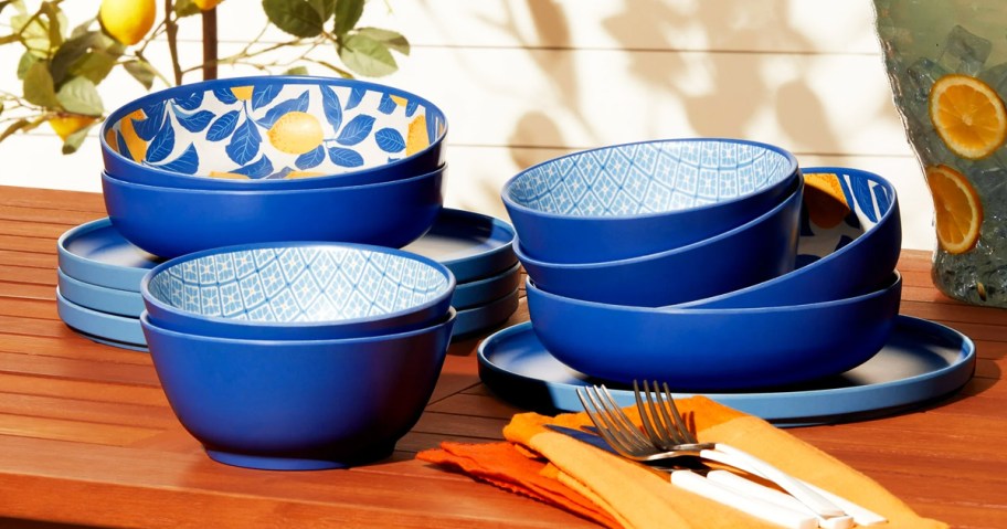 blue printed plates, bowls, and dinner bowls stacked on a patio table