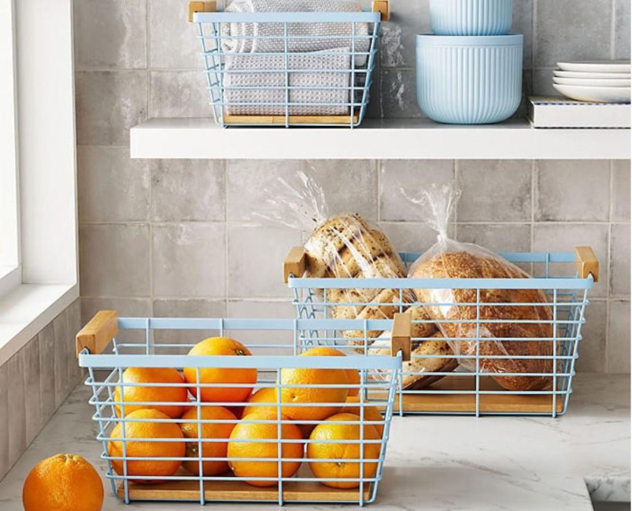 3 Wire Baskets on a counter and kitchen shelf