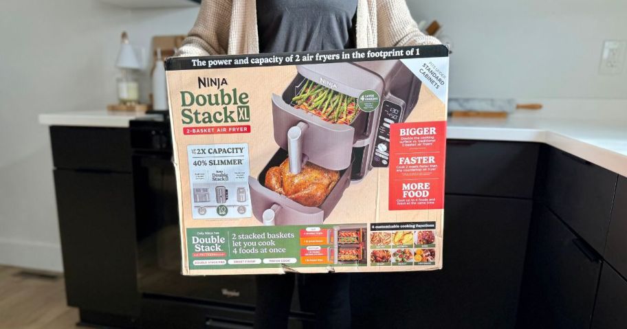 holding an air fryer in a box