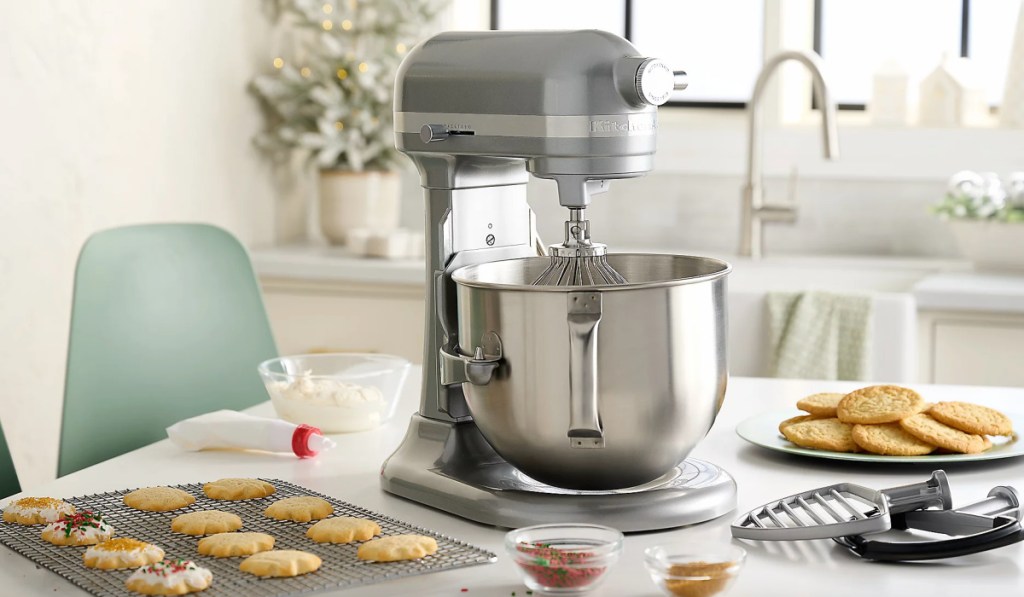 silver mixer in kitchen next to sheet of cookies
