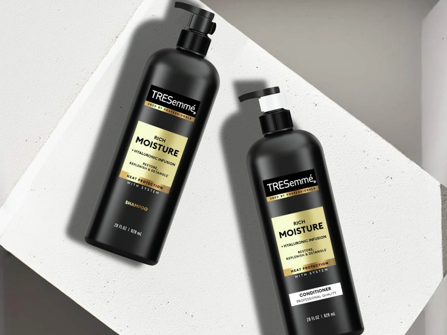 two black bottles of TRESemmé Rich Moisture Shampoo & Conditioner with pump tops