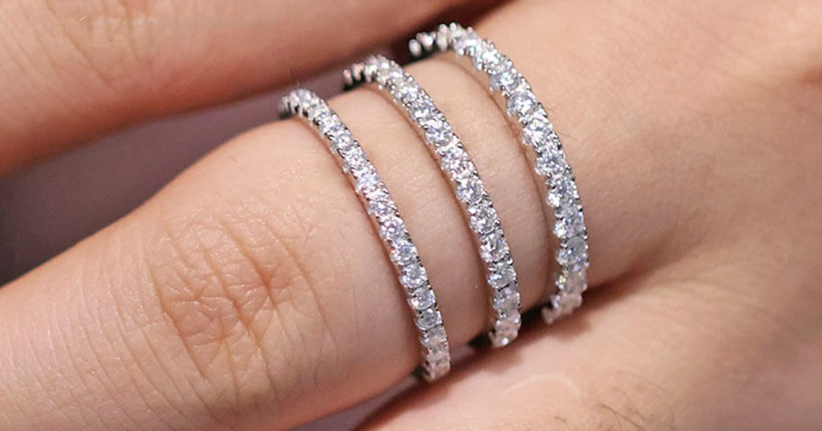 3 wedding bands stacked on a finger