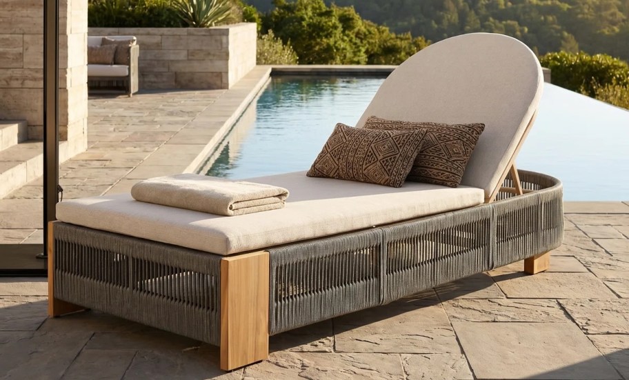 rope chaise lounger outside next to infinity pool on patio