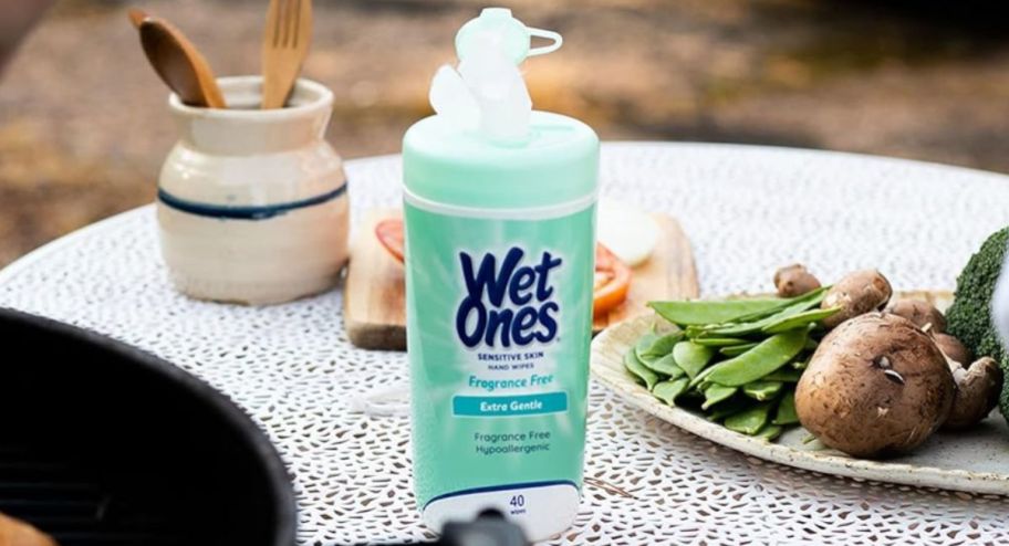 Wet ones canister on the table surrounded by food