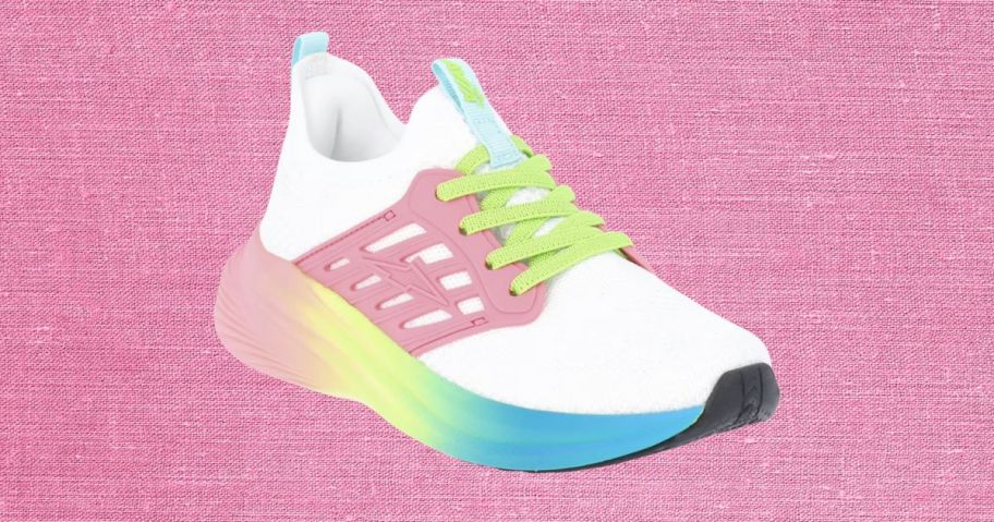 white, pink, green, and blue avia kids shoe against pink background
