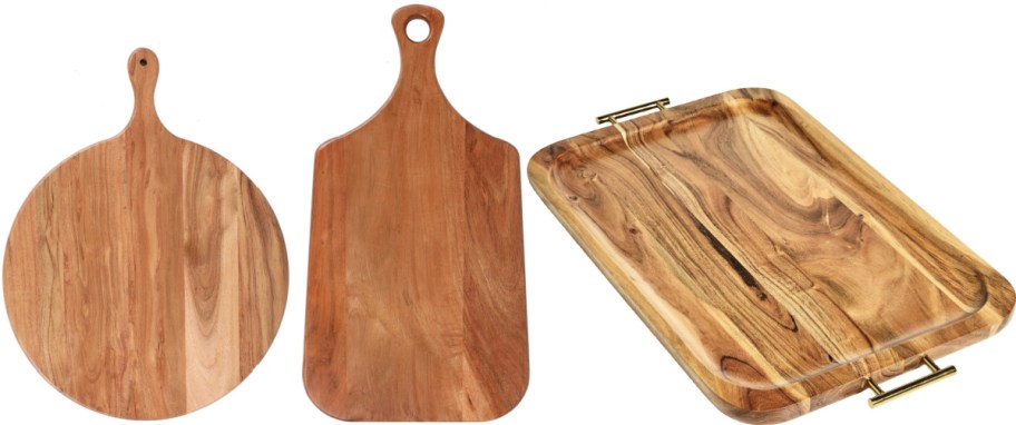 Two wooden cutting boards, one round and one rectangular, plus a rectangular serving tray with handles.