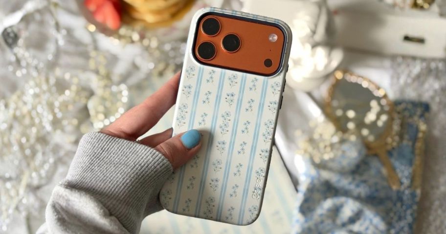 woman holding phone with casely phone case on it