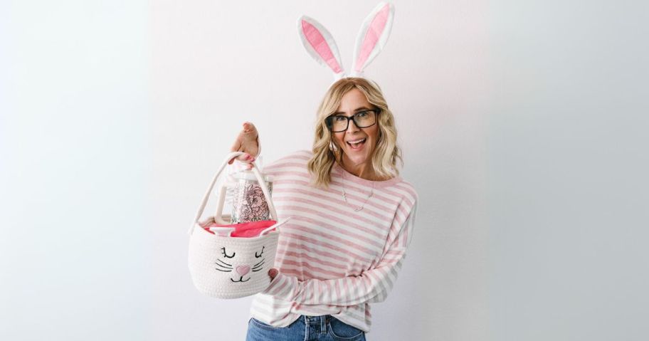 woman wearing easter bunny ears holding bunny basket