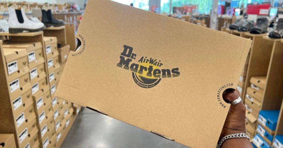 hand holding doc martens box in store