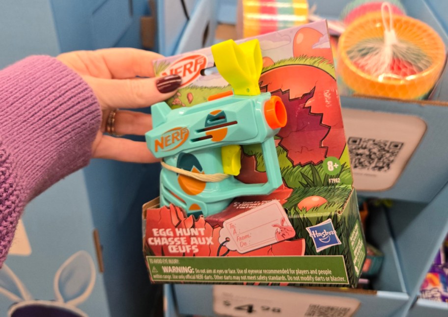 blue mini nerf gun in hand in store