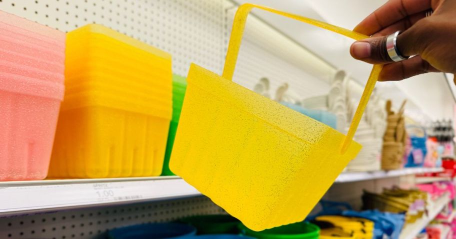 person holding yellow Spritz Plastic Berry Basket in store