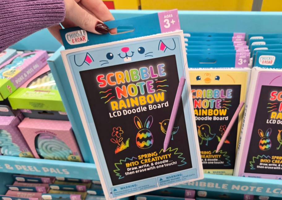 hand holding blue lcd rainbow drawing board in store