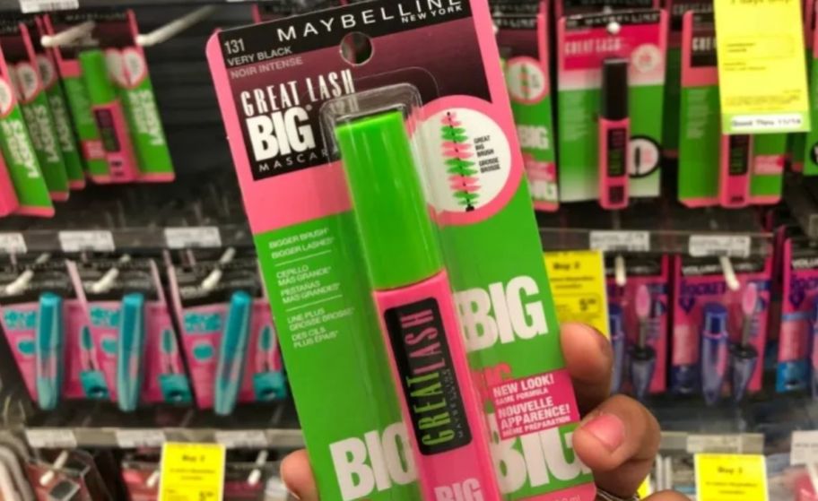 a womans hand holding a tube of great lash mascara