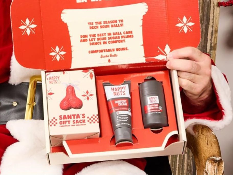 santa holding Happy Nuts Holiday Anti-Chafing Deodorant Festive Essentials Bundle Kit