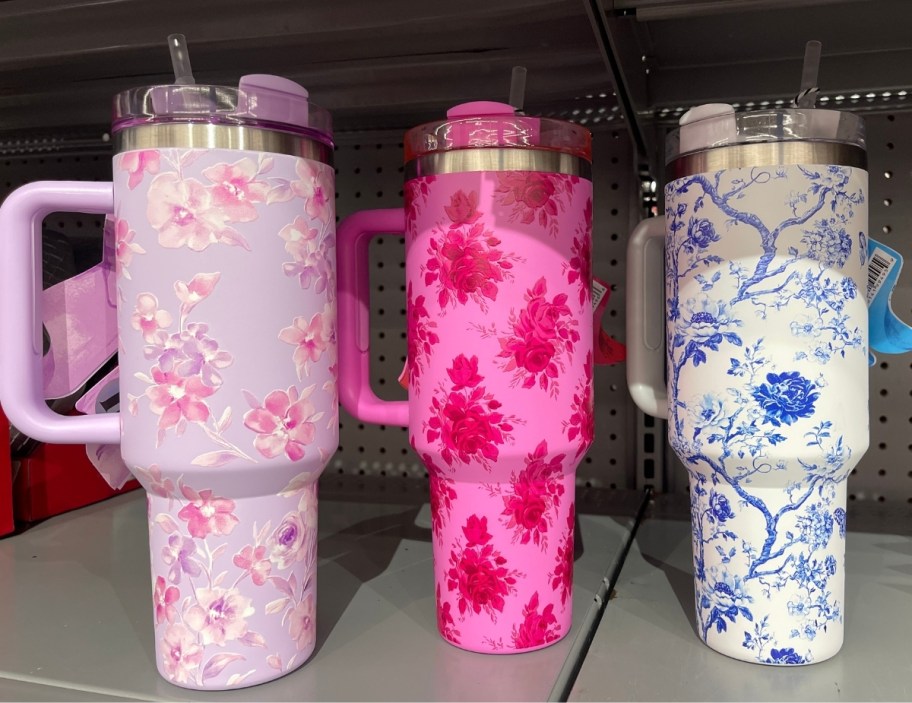 three floral print 40oz tumblers on a store shelf