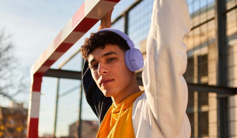 young man wearing purple jbl headphones