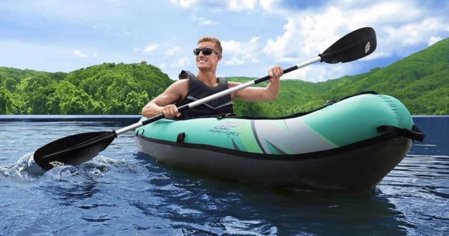 man in kayak on water