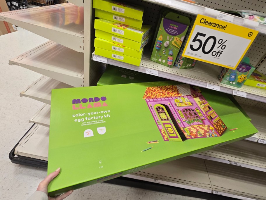 Brightly colored "Mondo Llama" egg factory kit on sale at a store. Sign shows a 50% clearance discount.