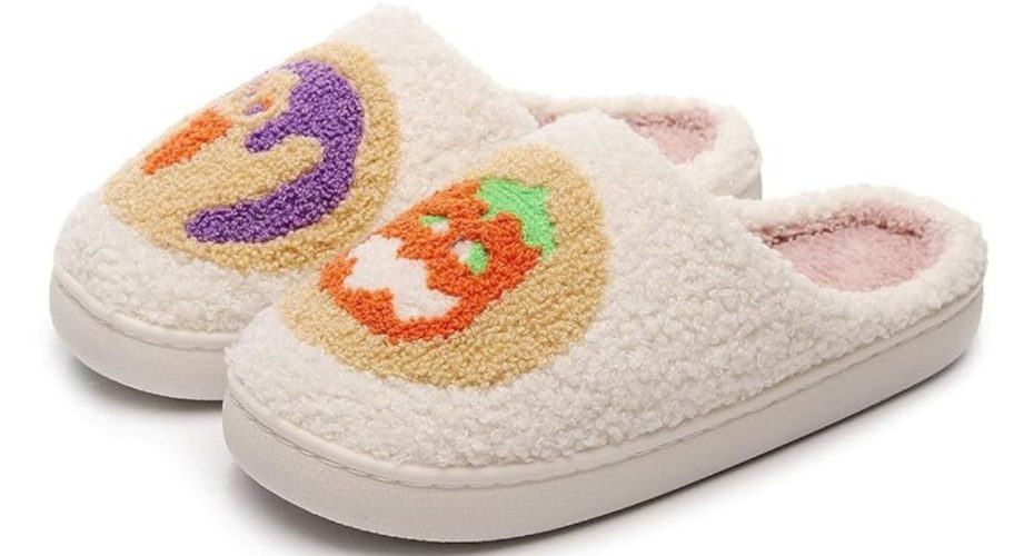 beige slippers with a ghost and pumpkin on them