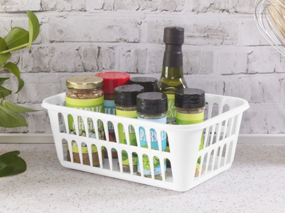 Sterilite Storage Basket on counter in kitchen with seasonings inside it
