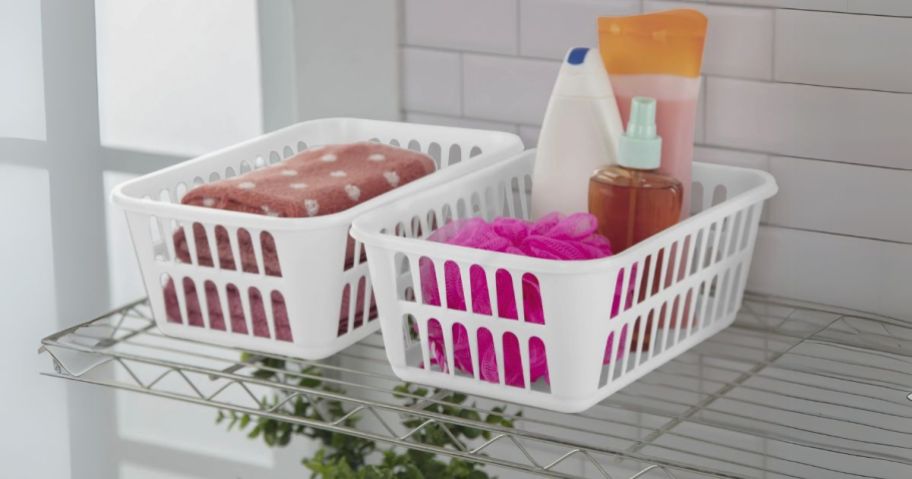 two Sterilite Storage Baskets on wire shelf with bathroom items inside them