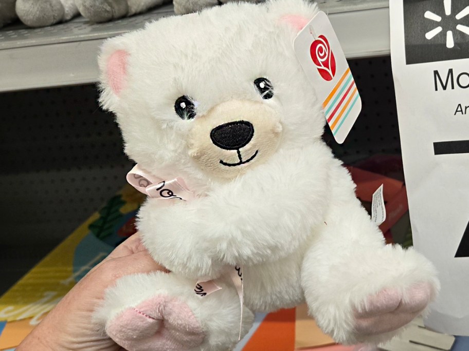 hand holding white bear plush