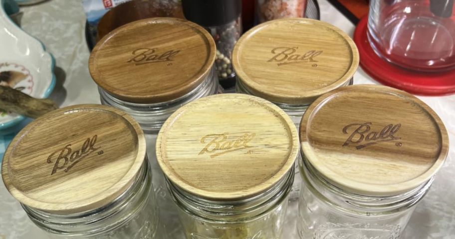 Ball Wide-Mouth Wooden Storage Lids 5-Pack on jars on counter