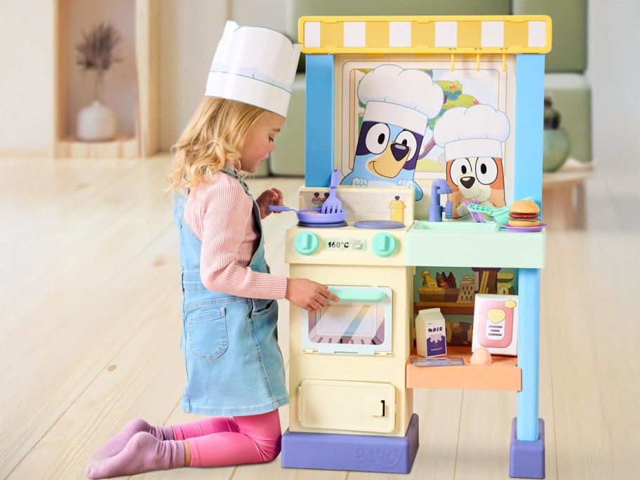 Girl playing with the Bluey Kitchen Playset