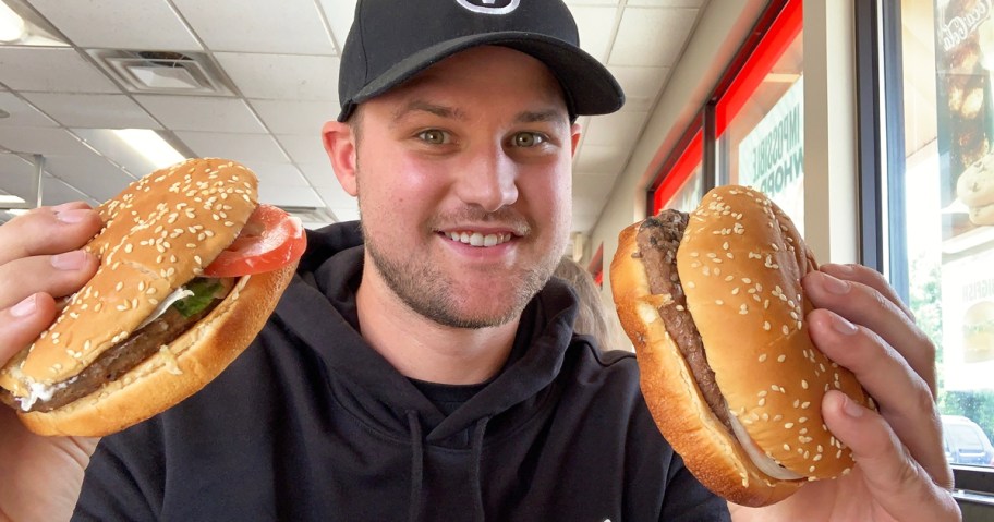 man holding up two Burger King burgers