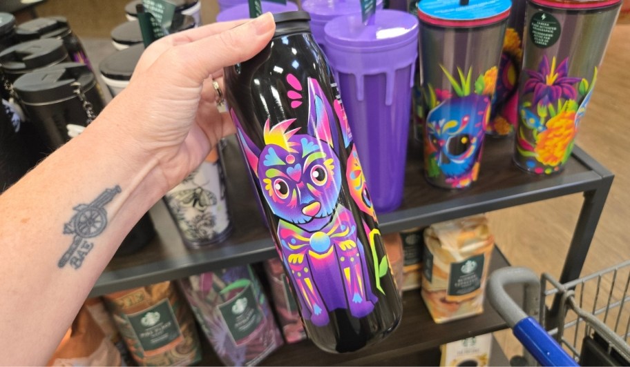 womans hand holding a DOD inspired dog tumbler