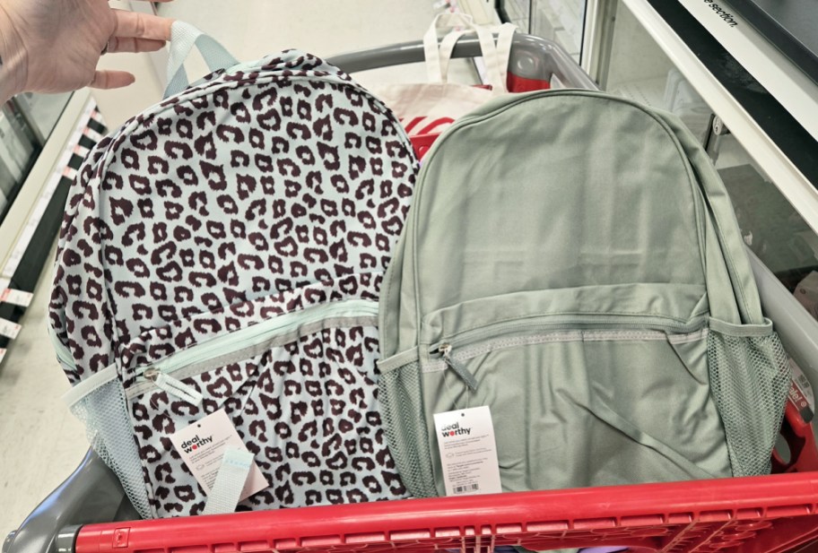 leopard print and mint green backpacks in a red shopping cart
