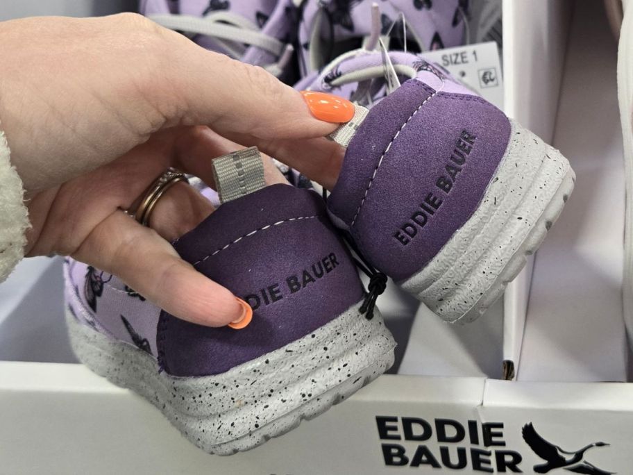 Hand holding a pair of Eddie Bauer Slip On Shoes