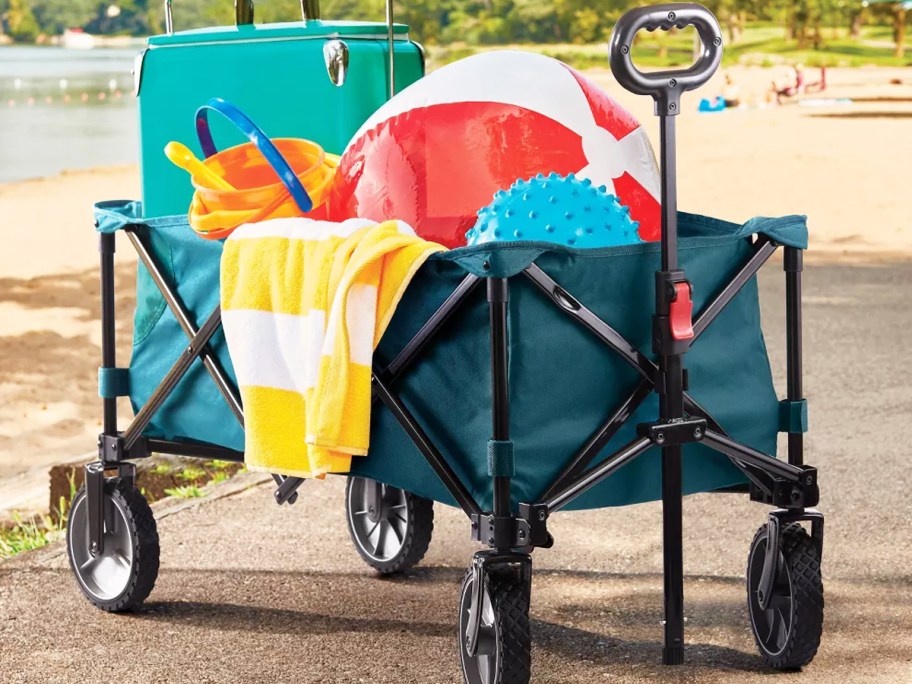 beach gear piled into a teal wagon