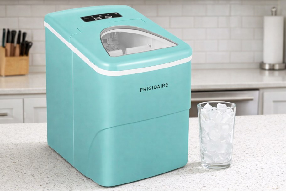 blue ice maker on kitchen counter with glass full of ice