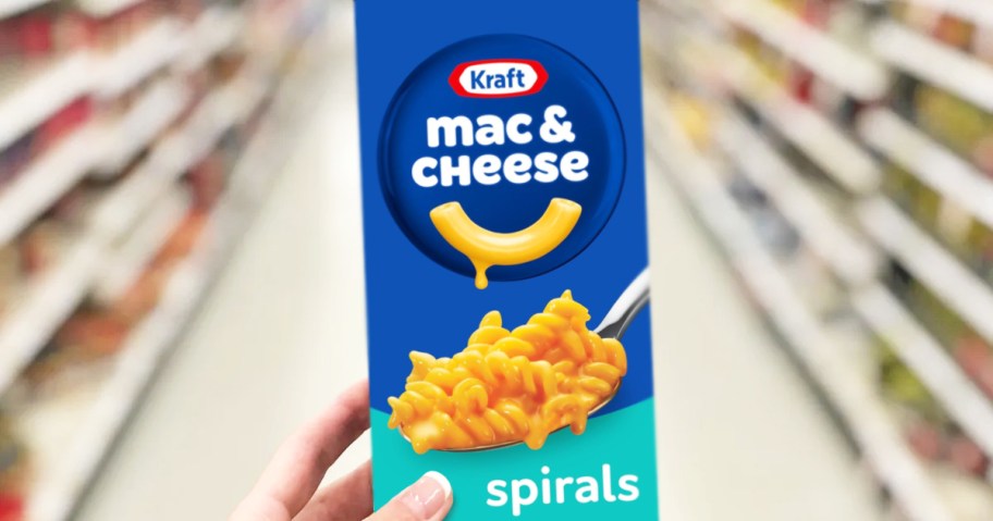 hand holding a box of Kraft Mac & Cheese Spirals in store