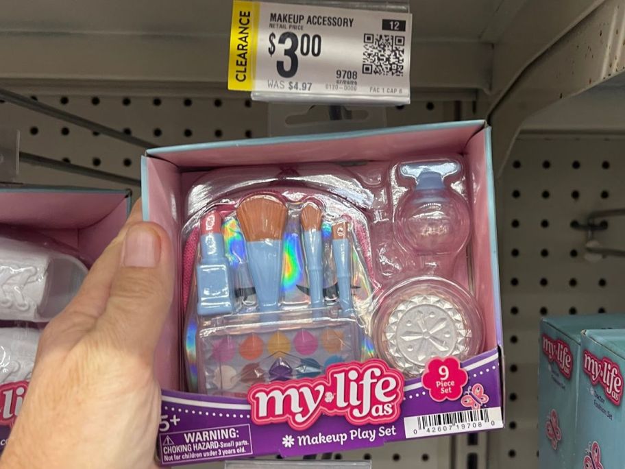 Hand holding a My Life As 9-Piece Makeup Play Set 