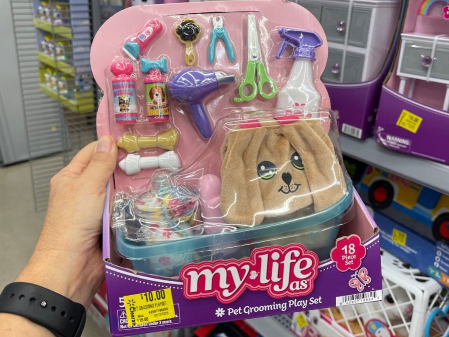 Hand holding a My Life As 18-piece Pet Grooming Play Set
