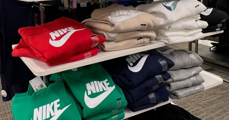 A display of folded Nike Hoodies