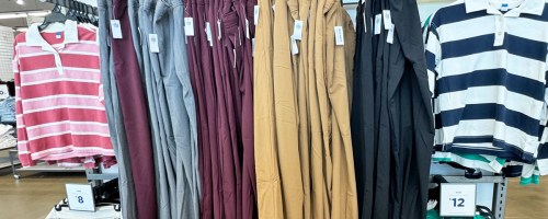 various colors of pants hanging on display in store