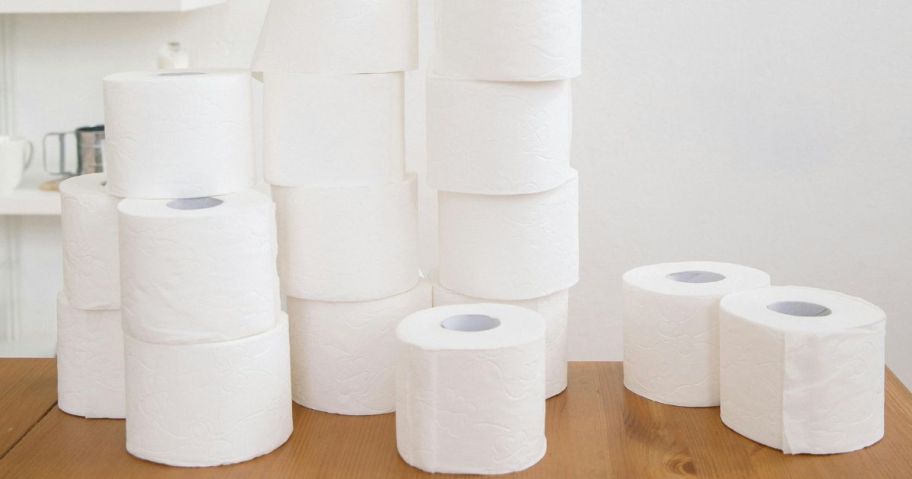 Rolls of toilet paper stacked on a table