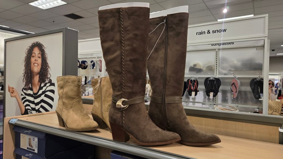 dark brown tall boots on store shelf