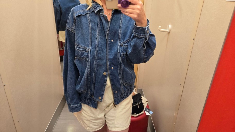 Woman wearing denim, bomber jacket and dressing room at target 