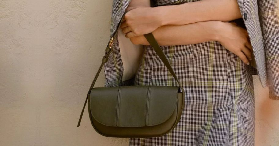 A woman holding a Time & Tru Purse