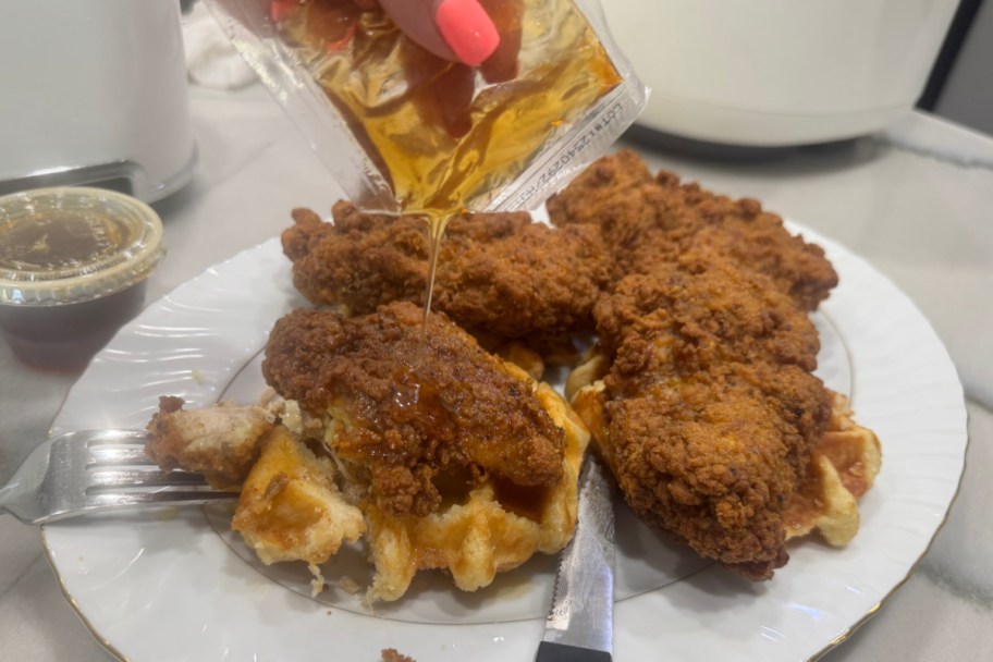 pouring hot honey over fried chicken