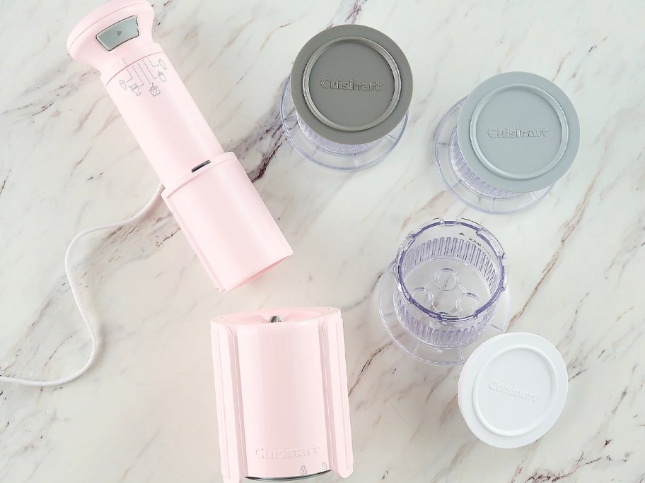 pink cusinart frozen treat maker with three pints and lids on counter