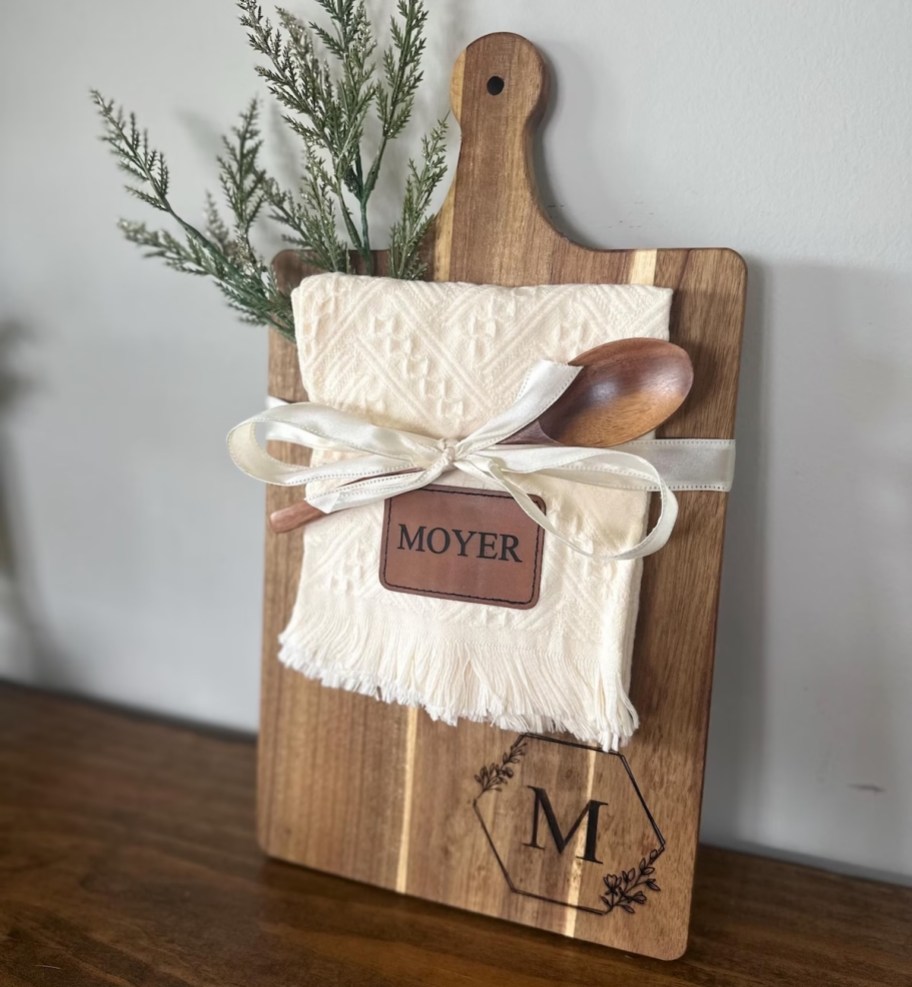 monogram cutting board with towel and wooden spoon