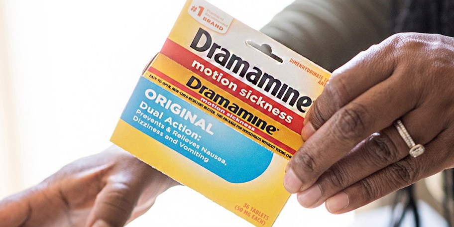 hand holding box of dramamine 