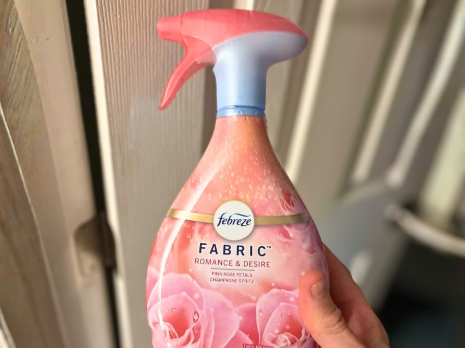 hand holding a bottle of febreeze fabric refresher