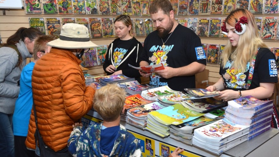 comic fans grabbing free comics